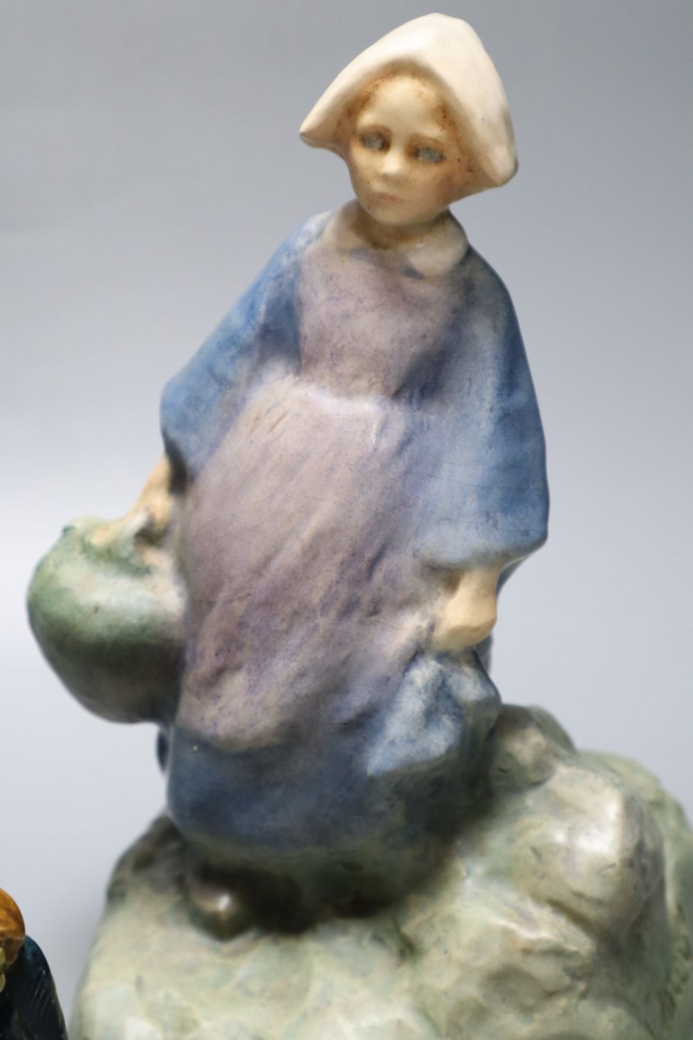 An Edmond Lachenal pottery figure of a Dutch girl modelled by Jazon, height 26cm, and a Continental group of a father and child